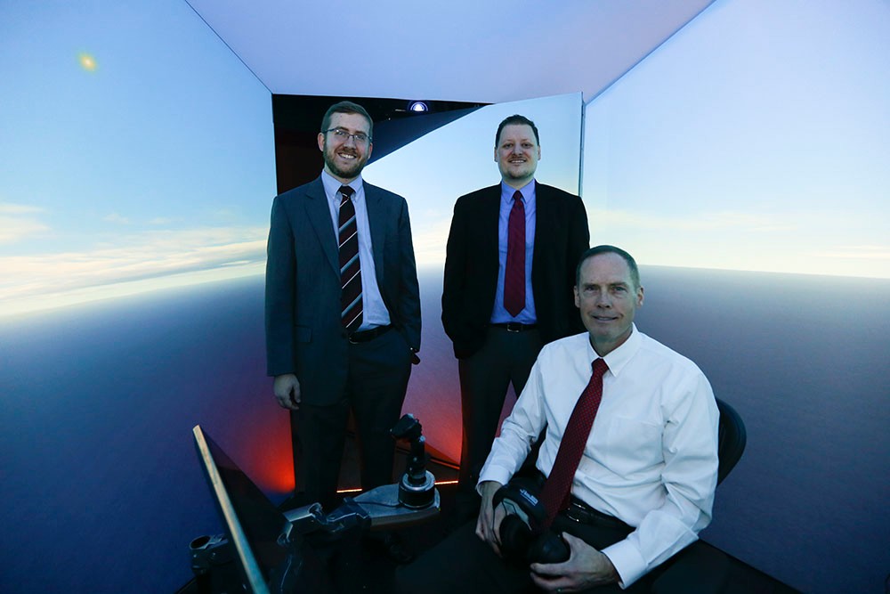 Nick Ernest, David Carroll and Gene Lee in flight simulator.