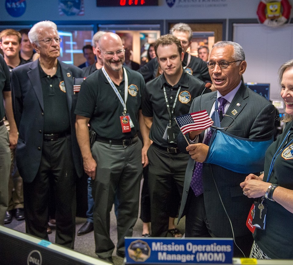 UC graduate Chris Hersman (smiling) celebrates the successful rendezvous of New Horizons with Pluto in 2015. (NASA)