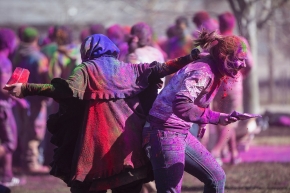 UC students throw colored powder on McMicken Commons as part of Holi Festival.