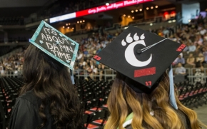 Two UC students enter BB&T Arena during Commencement on Friday, Aug. 4. 
