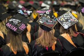 UC students wearing decorated mortarboards. 