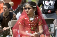 A student in traditional garb sits at Worldfest. 