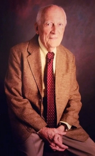 A distinguished 100-year-old gentleman poses for the camera. James Helmsworth, who pioneered the use of a heart-lung machine and was a UC professor of surgery, died.