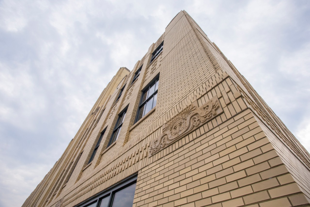 An art deco carving on the brick exterior of the 1819 Innovation Hub building.