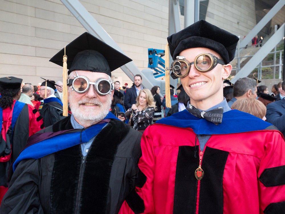 Two men in robes wearing steampunk goggles.