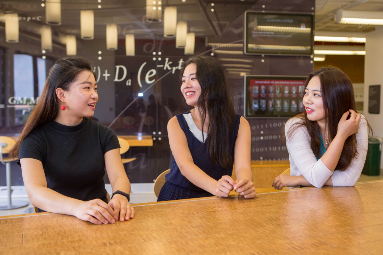 UC students Zijia Shen, left, Jingyi Zhu and Yixuan Zhang talk about their senior year in a study hall atop UC's Engineering Research Center. (Photo by Andrew Higley/UC Creative Services)