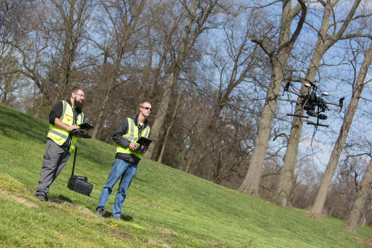 UC research associate Bryan Brown, left, and UC engineering student Austin Wessels operate a drone the university is using to capture traffic data and images for the Ohio Department of Transportation.
