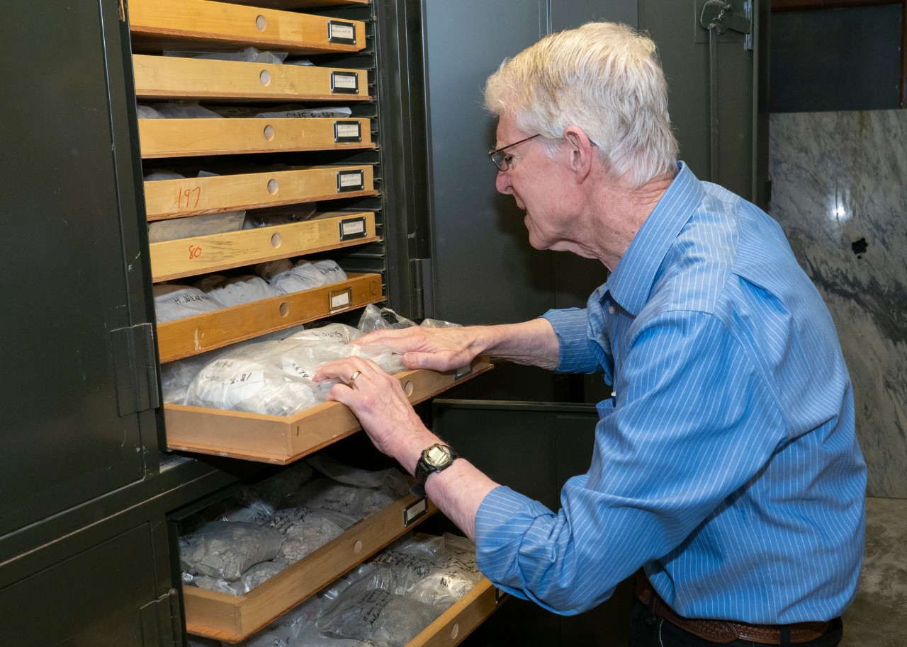 UC professor Warren Huff has filled rows of wall-to-ceiling storage cabinets with rock and clay samples he has collected all over the world for his research. 