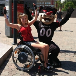 Sara Whitestone poses with the Bearcat soon after receiving her power-assist chair.