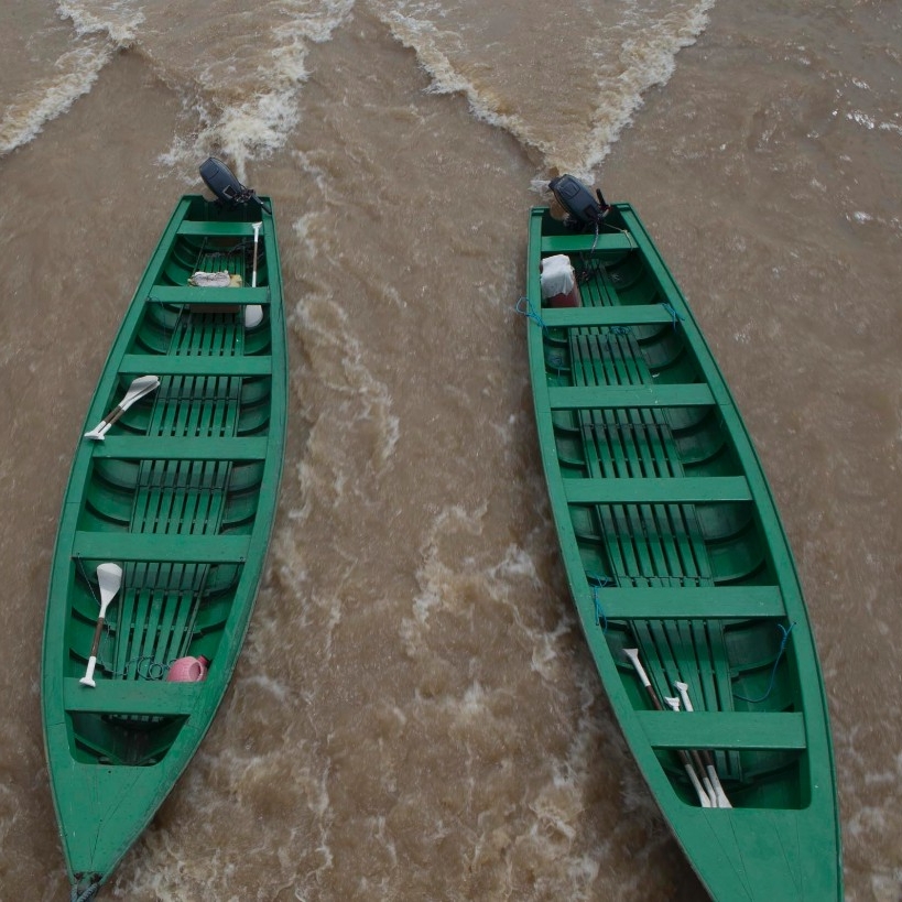 Motorboats idle in the surf.