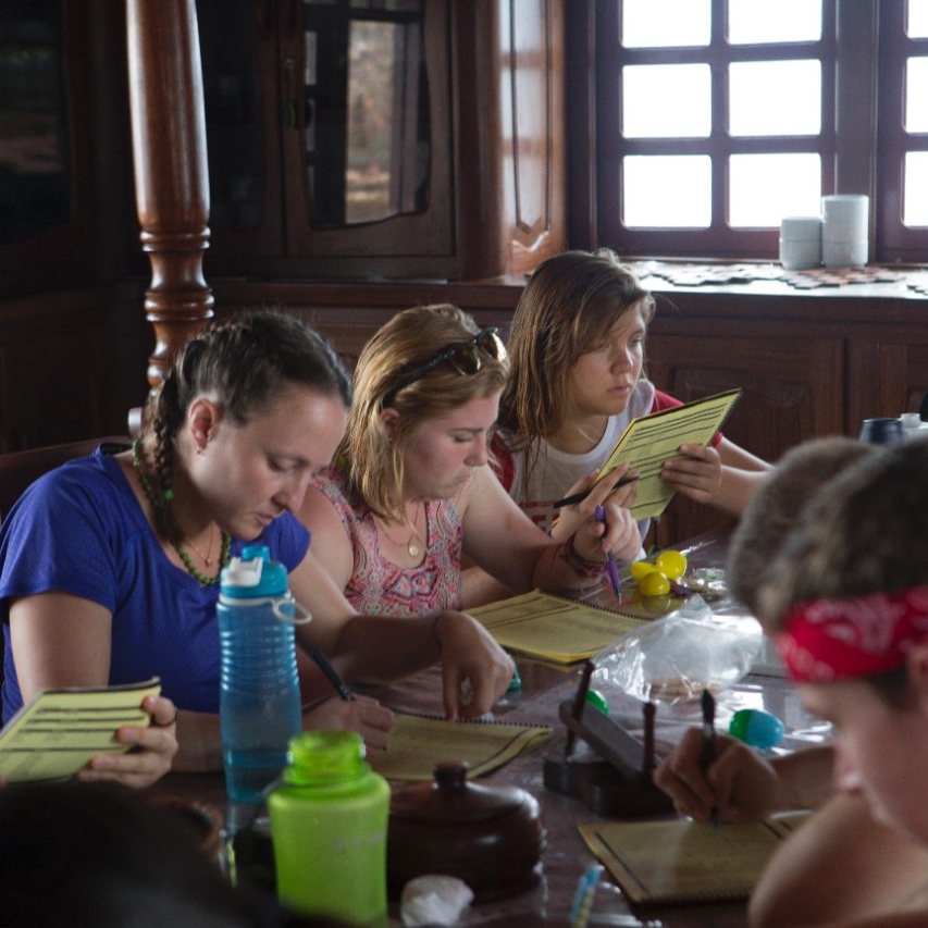 Students study at a communal table.
