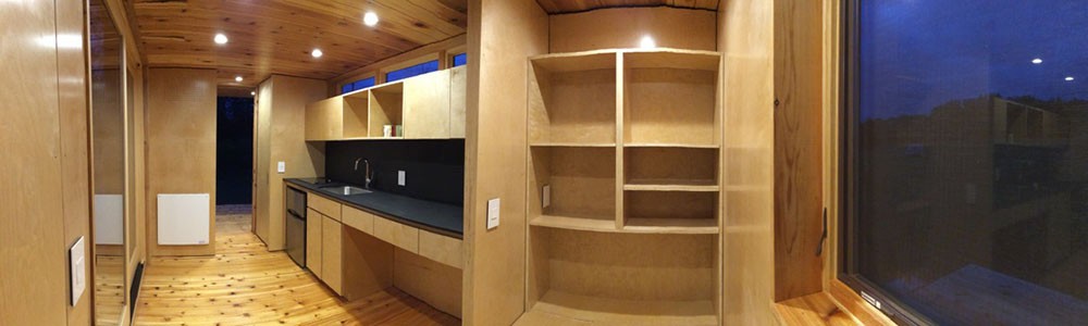 The students' craftsmanship extends inside the tiny house with beautiful woodwork. Photo/provided A panoramic view of the interior of the tiny house, featuring detailed woodwork.