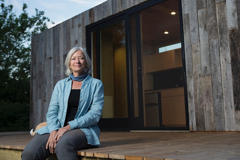 Photo/Andrew Higley/Creative Services Land steward Adrienne Cassel sits on the deck of her tiny house on the Kamama Prairie.