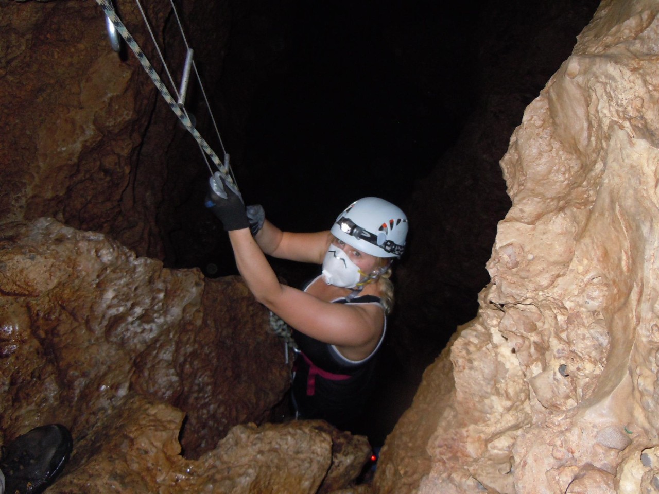UC biology student Amanda Powers wears a dust mask to protect her lungs from fungal disease while looking for cavefish in a cavern in Sierra del Abra Tanchipa.