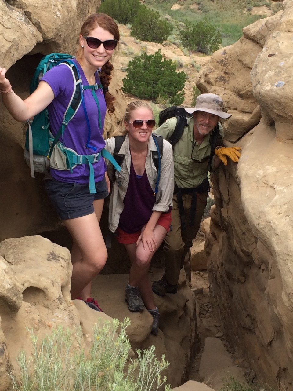 UC graduate Elizabeth Haussner, left, Katelyn Bishop and UC geography professor Christopher Carr hike a trail in New Mexico.