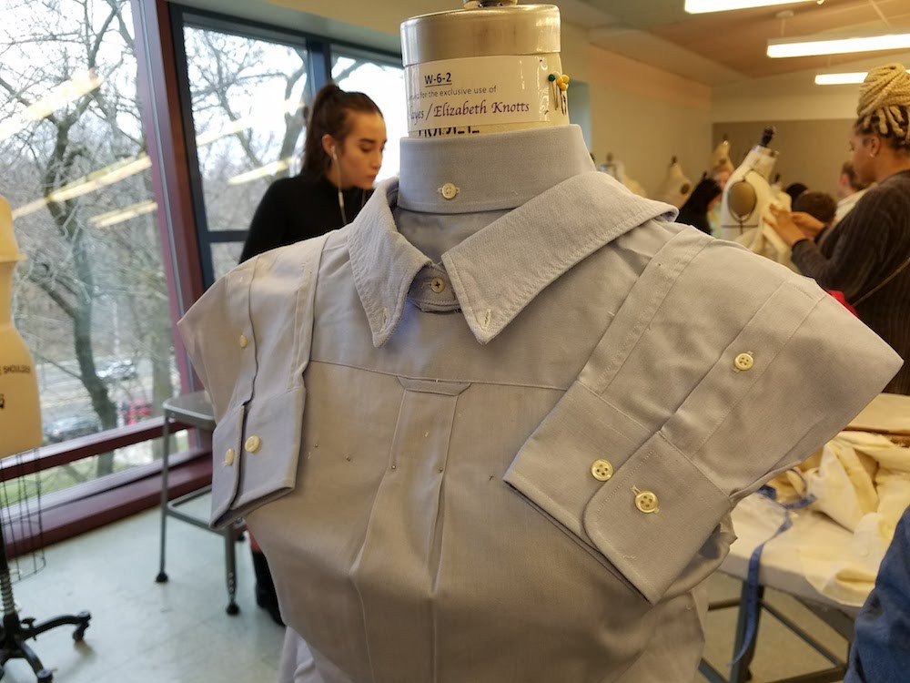 A garment made from two blue button-up shirts on a dress form 