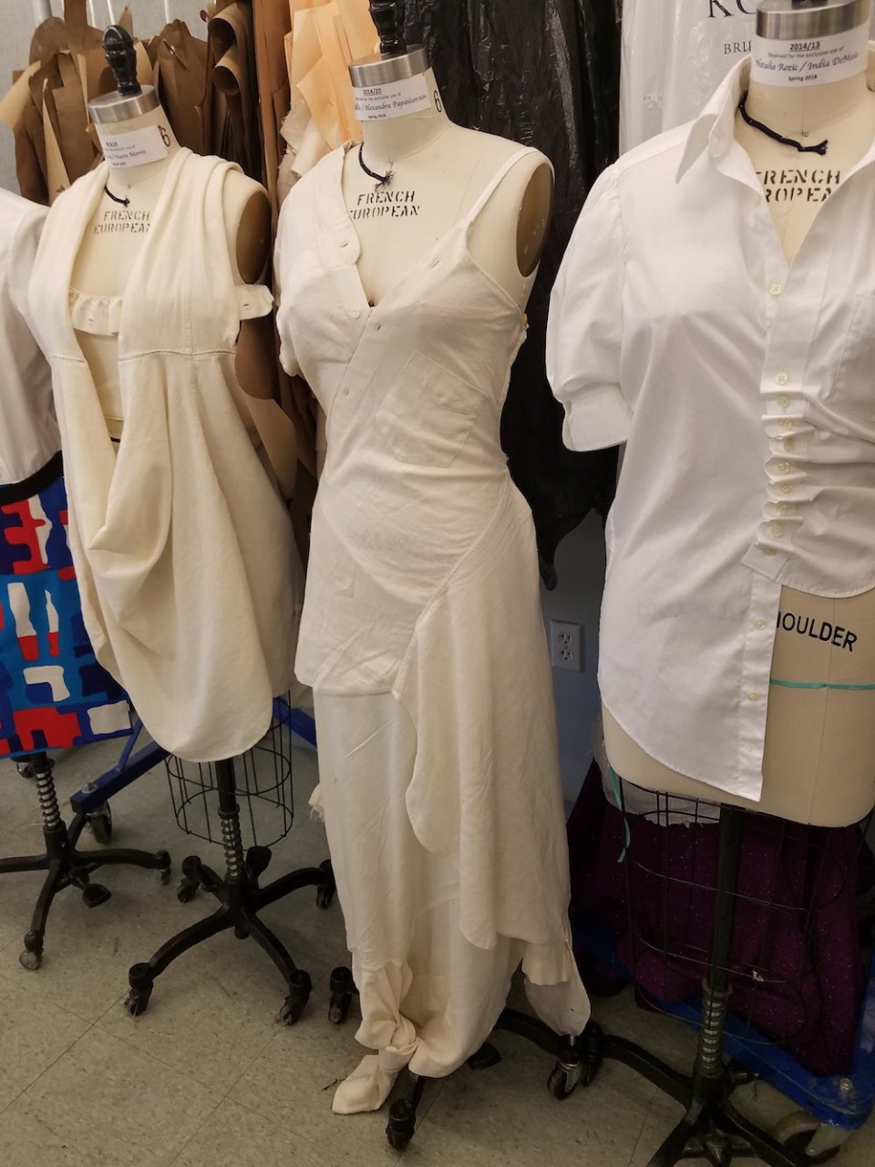 Garments made from two white button-up shirts on dress forms