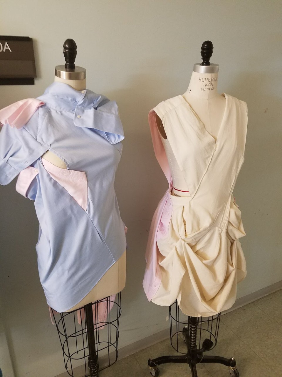 Two garments made from two white button-up shirts on dress forms