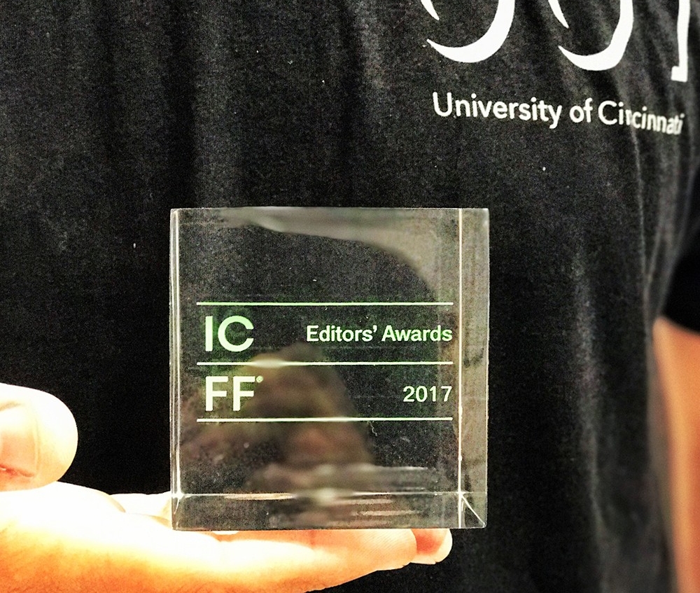 The square glass ICFF Editors' Award sits in someone's hand.