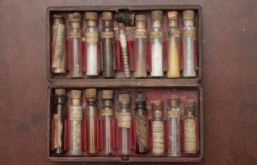 Vintage medical kit with vials of drugs