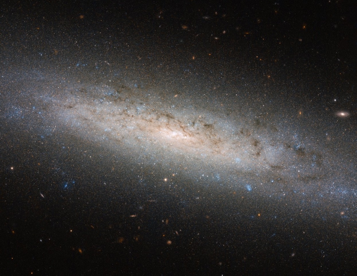 The Hubble Space Telescope captured this image of the galaxy NGC-24. Astrophysicists suspect these galaxies are surrounded by extended halos of dark matter. (NASA)