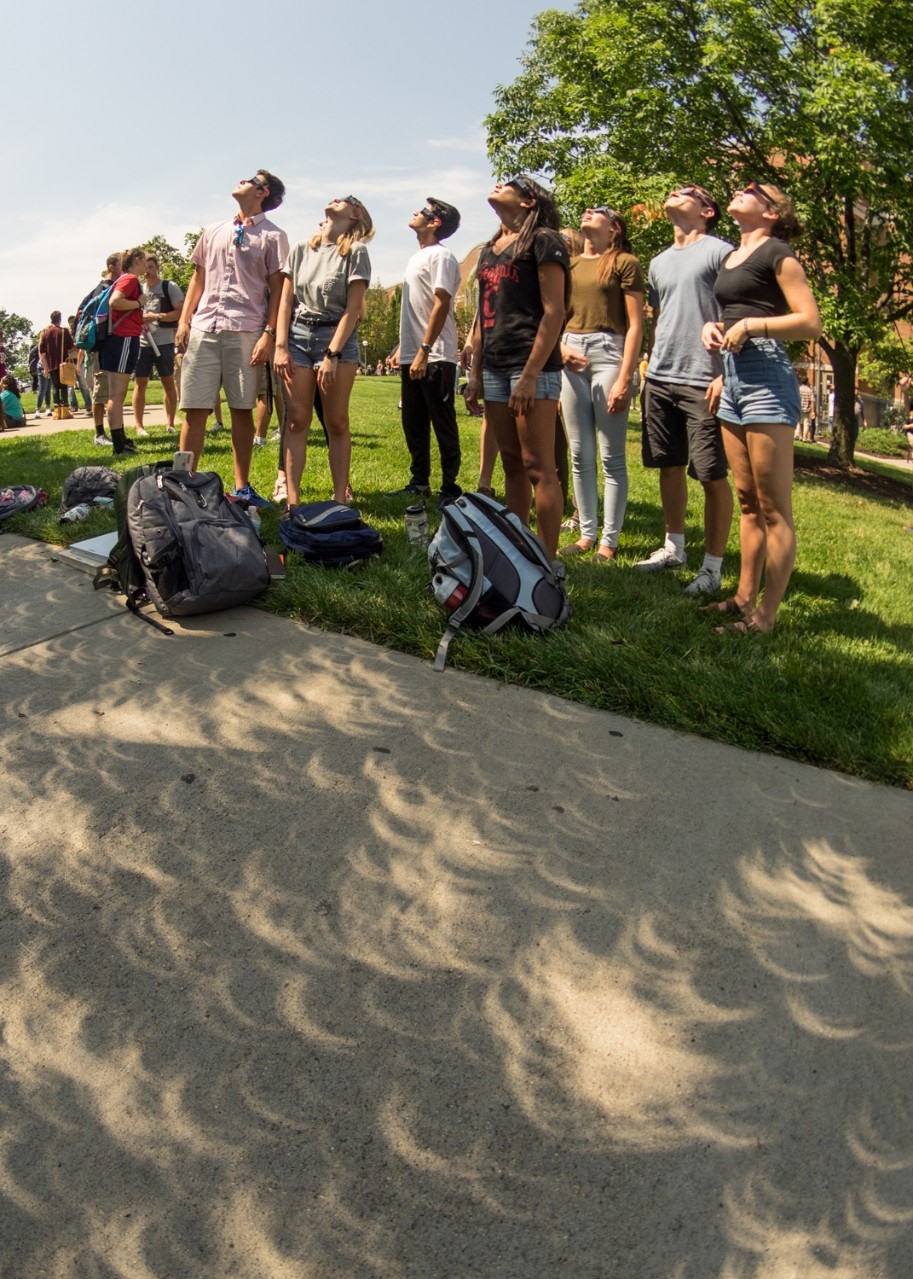 students observe solar eclipse