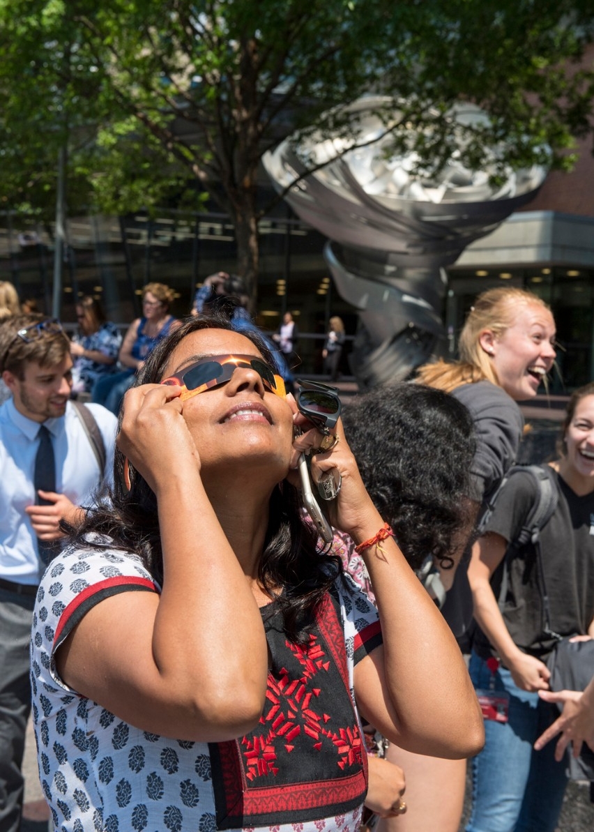 students observe solar eclipse