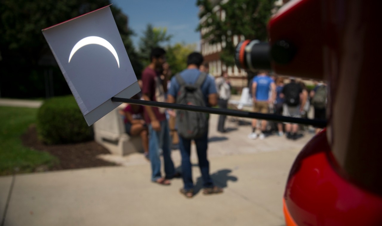 students observe solar eclipse