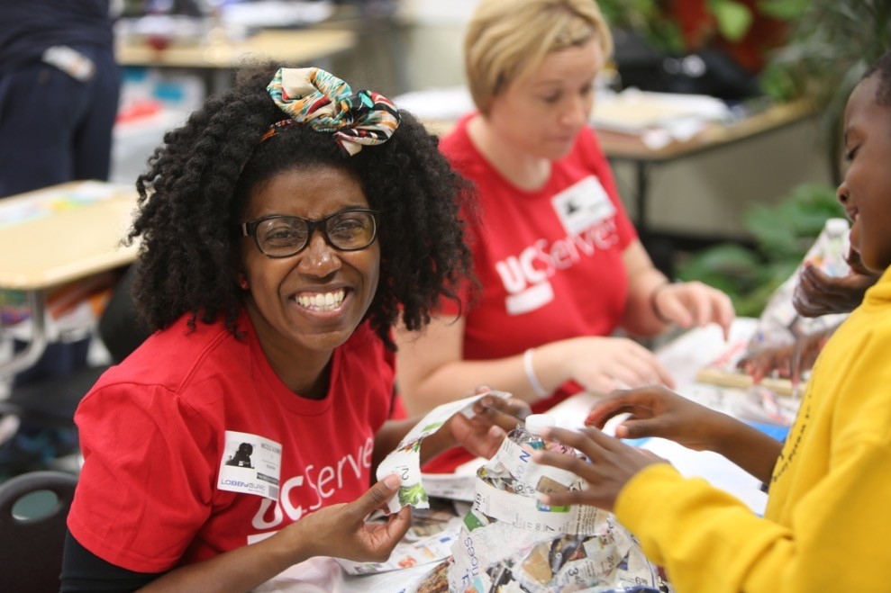UC Serves volunteers engage with student