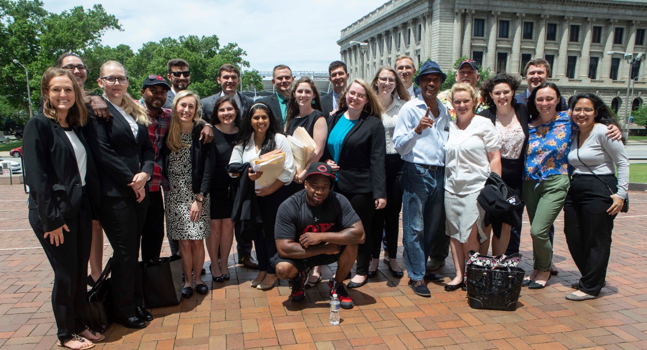 UC College of Law students pose outside the Cuyahoga County Justice Center with some of the people they have helped exonerate as part of UC's Ohio Innocence Project.