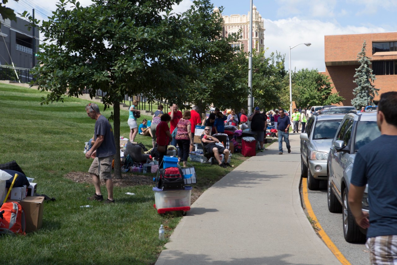Families wait to unload items to help students move in to the dorms.