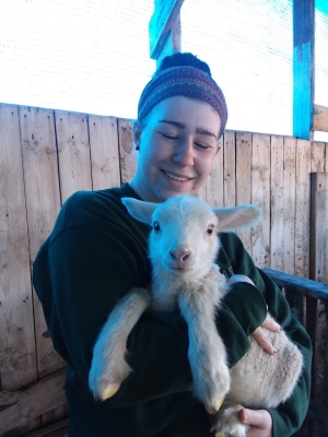 Young woman holding a lamb