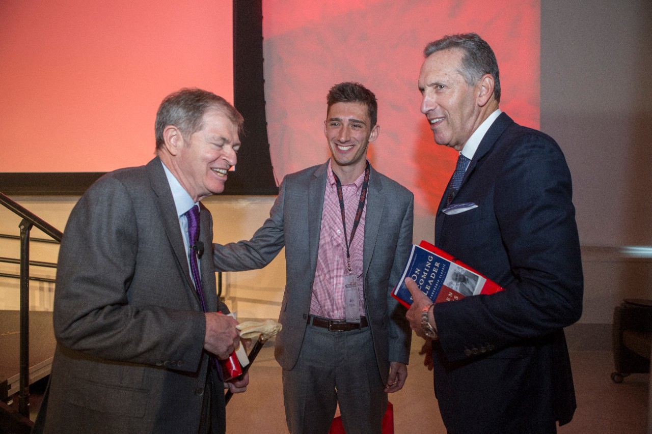 From left to right, Myron Ullman III, Jack FitzGerald, and Howard Schultz share a laugh after the conclusion of the Warren Bennis Leadership Experience