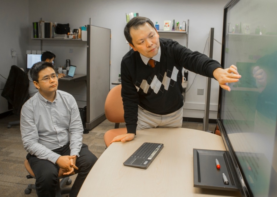 UC graduate student Xiaoyu Jin, left, and UC computer science professor Nan Niu studied the ways that software developers used the Internet to solve coding tasks.