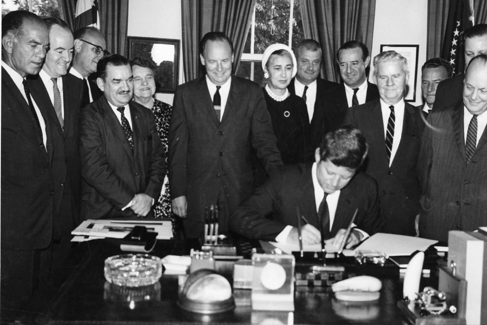 Several members of John F. Kennedy's White House cabinet watch as he signs the Fulbright-Hays Act in 1961. photo/courtesy Fulbright Facebook