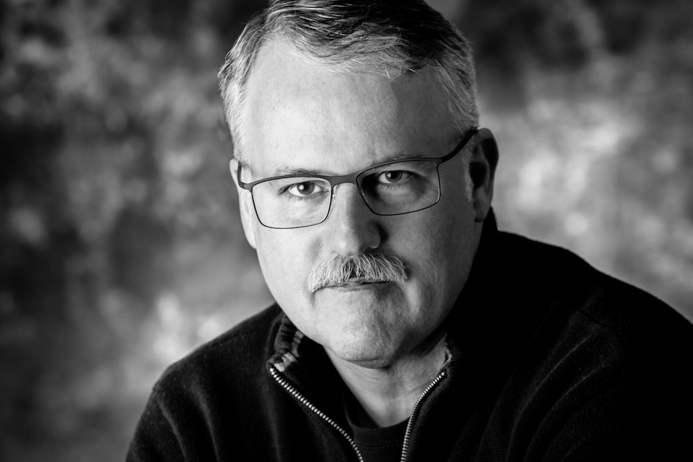 Black and white headshot of Barry Hutzel, who studied industrial design at DAAP from 1979-84.