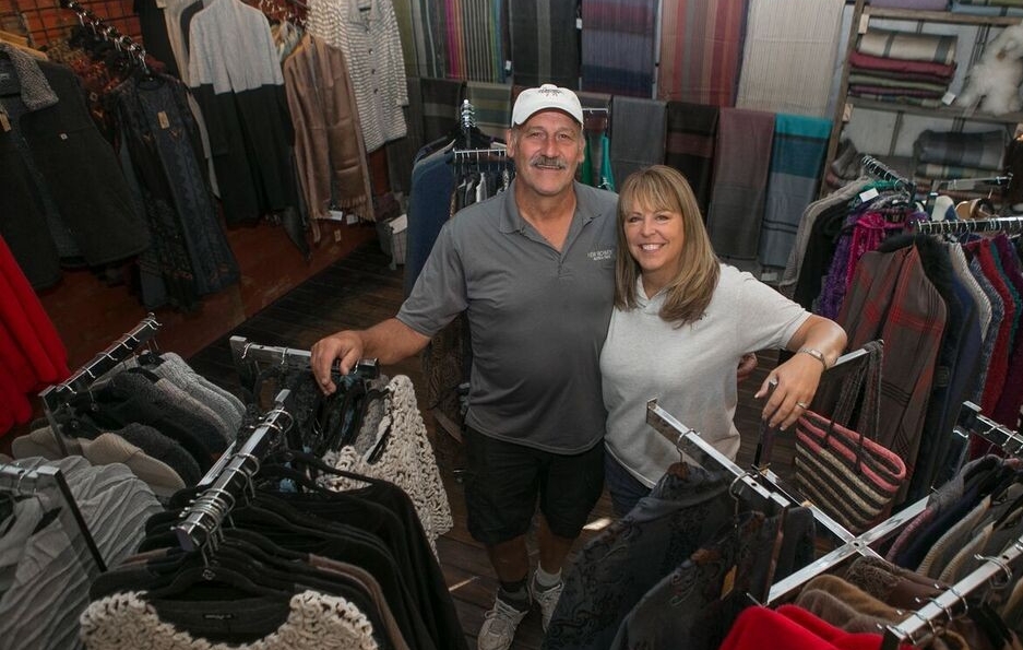 Wahl and Lori pose in their alpaca goods store surrounded by sweaters and scarves . photo/Joseph Fuqua II/UC creative Services