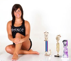 Harrington poses with past dance trophies.