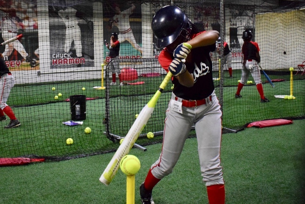 CPS student practices T-ball at the Reds Youth Academy during UC's Home Base summer camp. photo/Cincinnati Reds