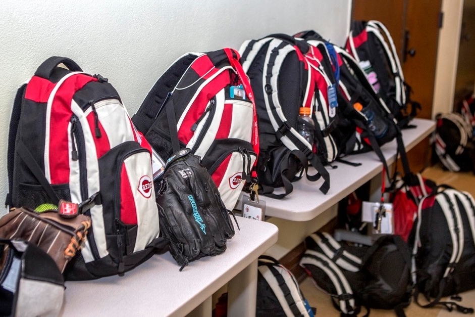 Cincinnati Reds branded backpacks line the hallway in UC's Blegen Library while UC Home Base summer campers take yoga classes. photo/Joseph Fuqua II/UC Creative Services