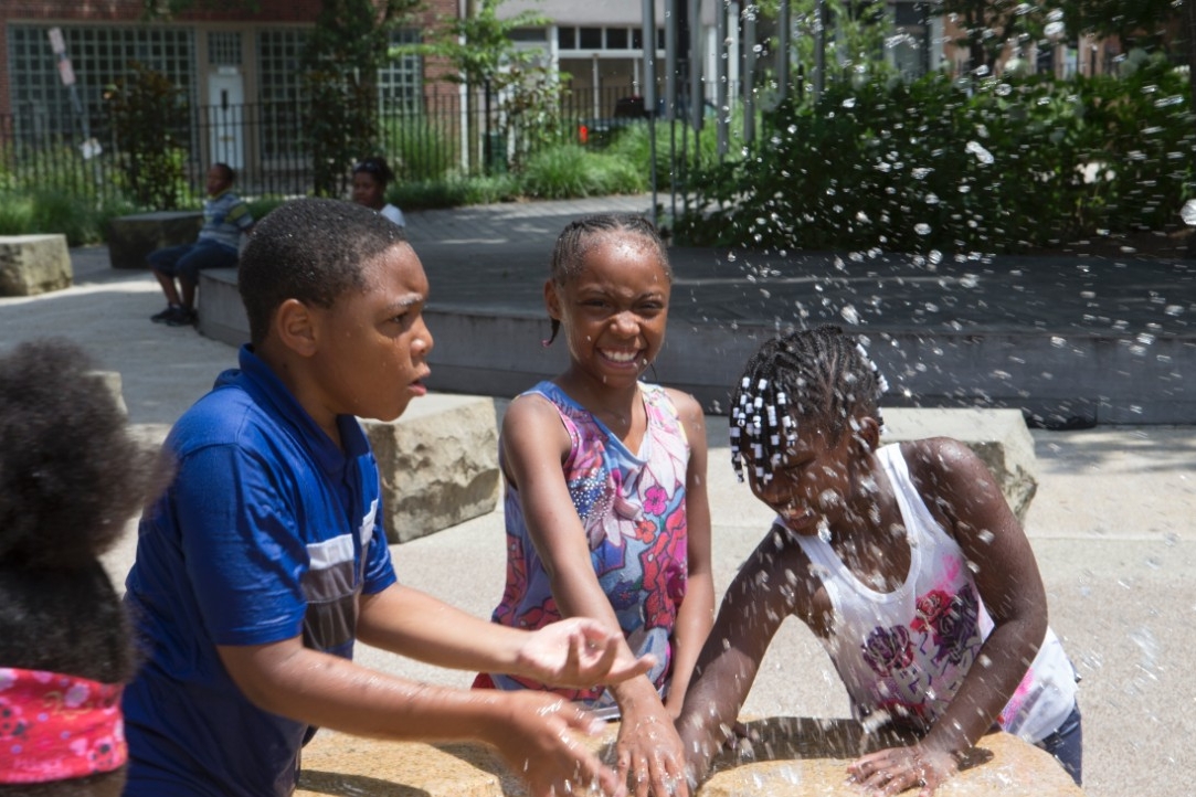 UpSpring summer campers, Kenton M., Joli Martin and Jaslene R., enjoy the sun and fun at Washington Park. Photo/Joe Fuqua/UC Creative Services