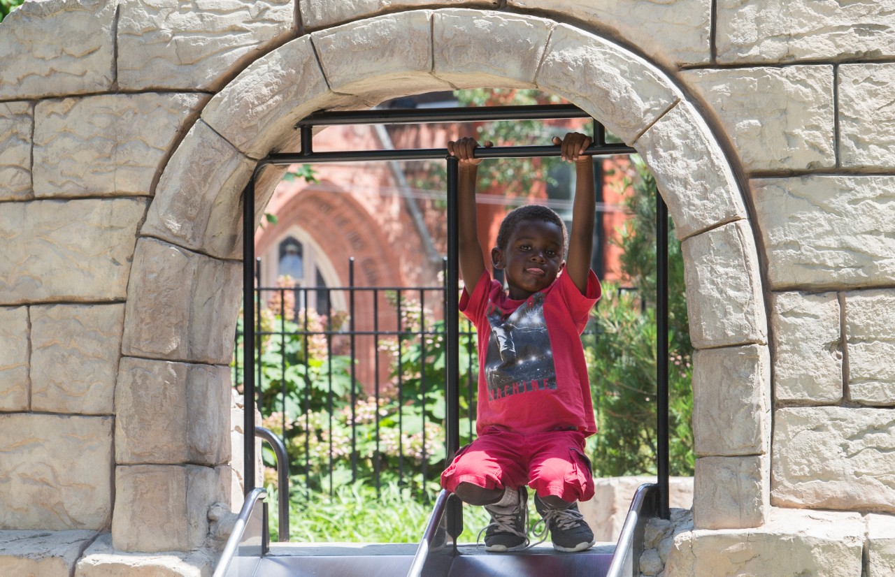 UpSpring summer camper enjoys the sun and fun at Washington Park. Photo/Joe Fuqua/UC Creative Services