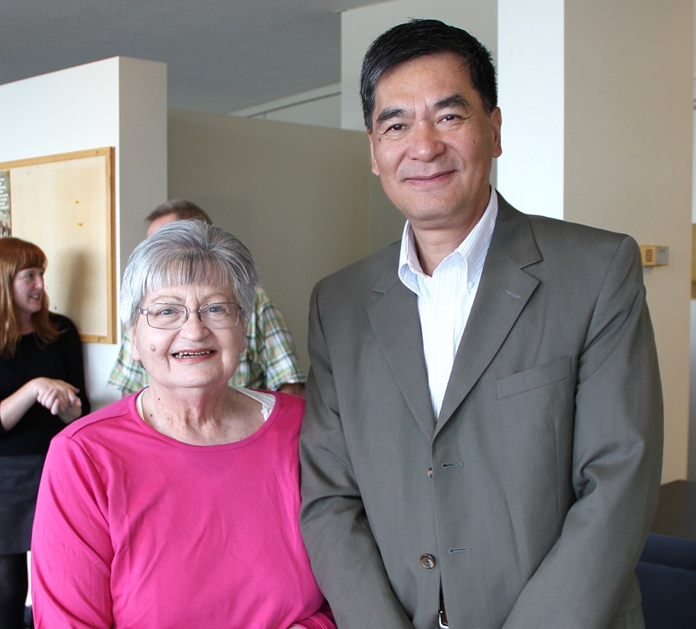 Janice Hutzler stands next to Dean Xuemao Wang at her 60th work anniversary party
