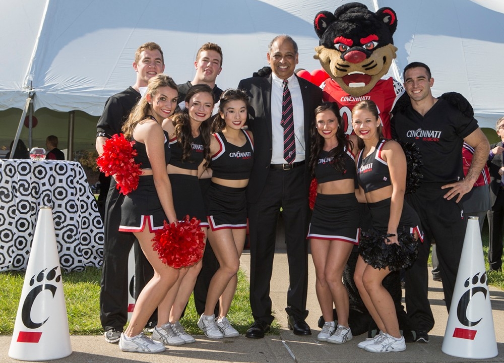 President Neville Pinto poses with the UC Cheerleading squad following his inauguration