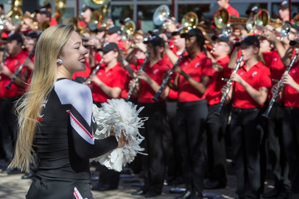 UC cheerleaders and the band welcome Neville Pinto during the inauguration ceremony