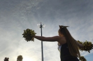 The silhouette of a cheerleader against a sunset sky.