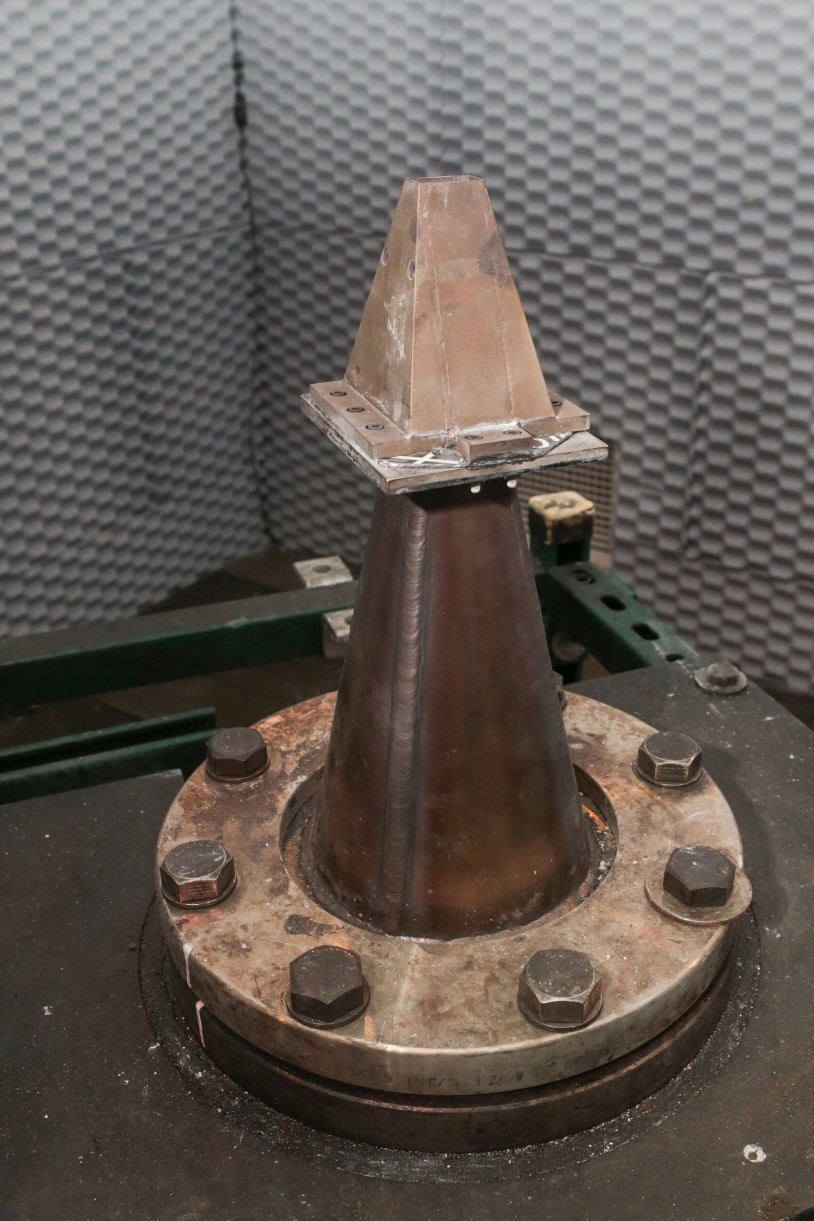 A jet engine is mounted to the floor in a UC engineering lab.