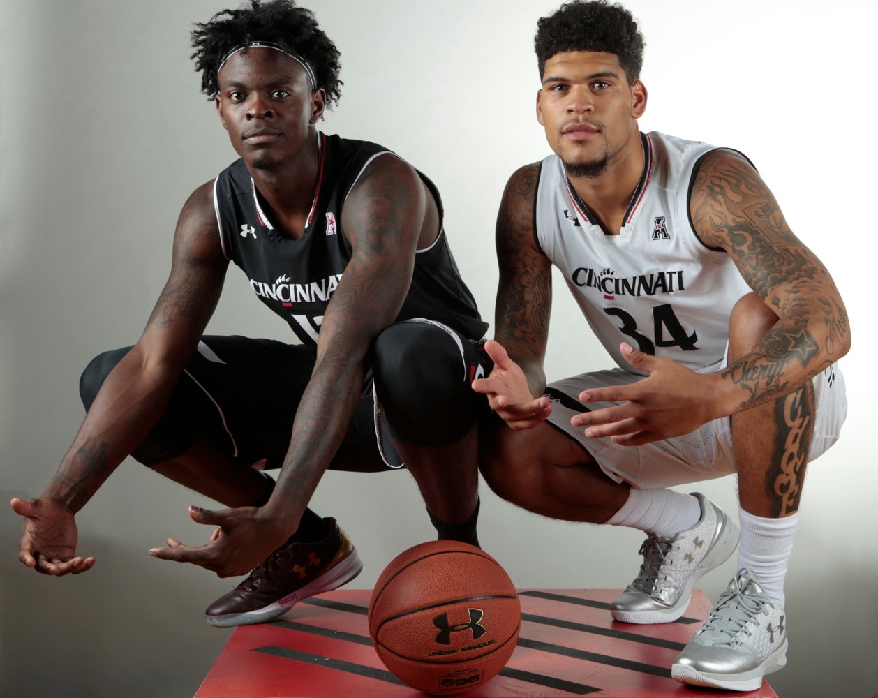 Two UC basketball players show off their Under Armour uniforms. photo/Andrew Higley/UC Creative Services