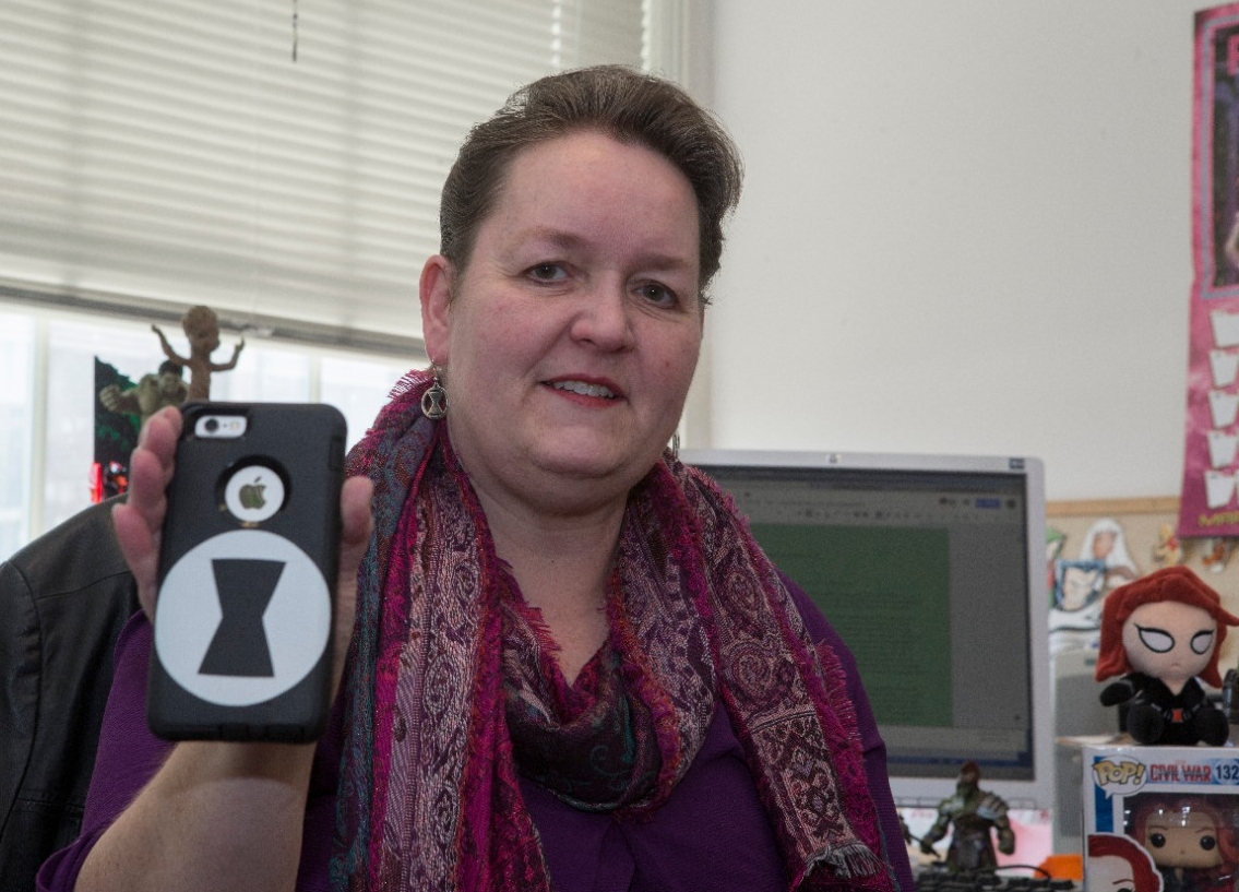 UC English professor Rebecca Borah holds up her Black Widow-themed iPhone case.