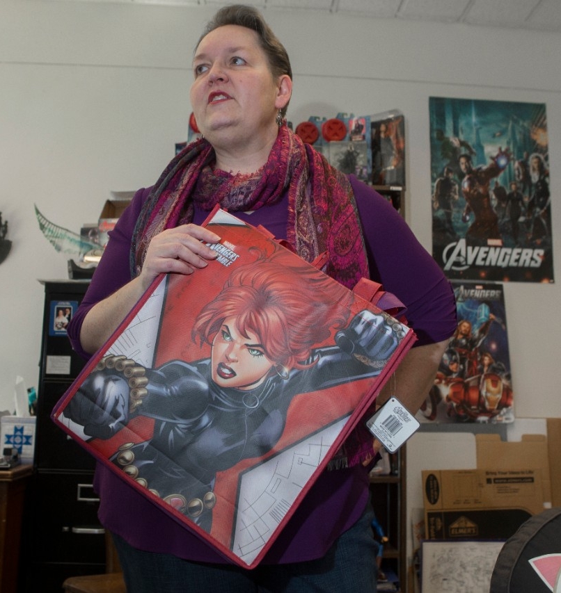 UC pop culture expert Rebecca Borah holds up a Black Widow tote bag in her office in McMicken Hall. Borah said Black Widow is the most controversial character in the Marvel Cinematic Universe.